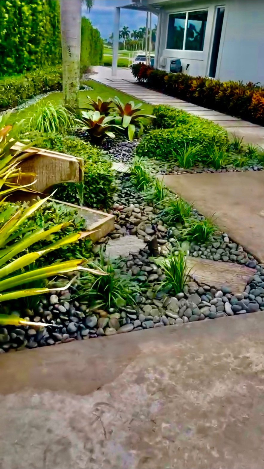 Lush luxury landscaped garden with stone path and curated shrubbery